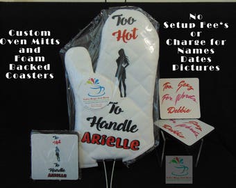May include: White oven mitt with the text "Too Hot To Handle Arielle" and a silhouette. Includes matching coasters with the text "Too Sexy For Words Debbie". The image also shows the text "Custom Oven Mitts and Foam Backed Coasters".