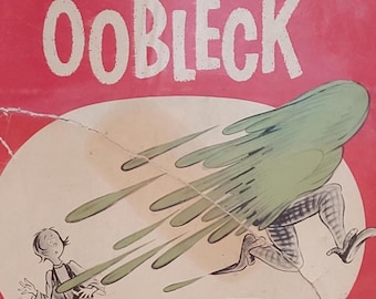 May include: A red hardcover book with the title "Bartholomew and the Oobleck" by Dr. Seuss. The cover features an illustration of a green creature with long legs and a boy looking up at it.