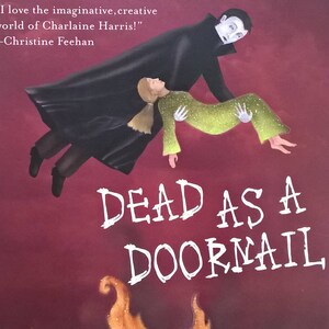 May include: A book cover for "Dead as a Doornail" by Charlaine Harris. The cover features a vampire carrying a person, with flames at the bottom. The author's name is in large green letters.