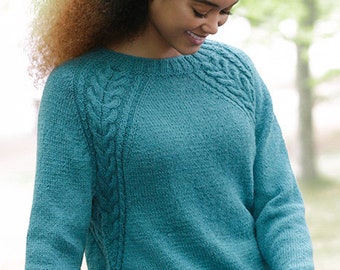 Knitted sweater with cables and raglan, worked top down.