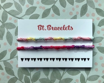 Set of two twisted bracelets pink/yellow