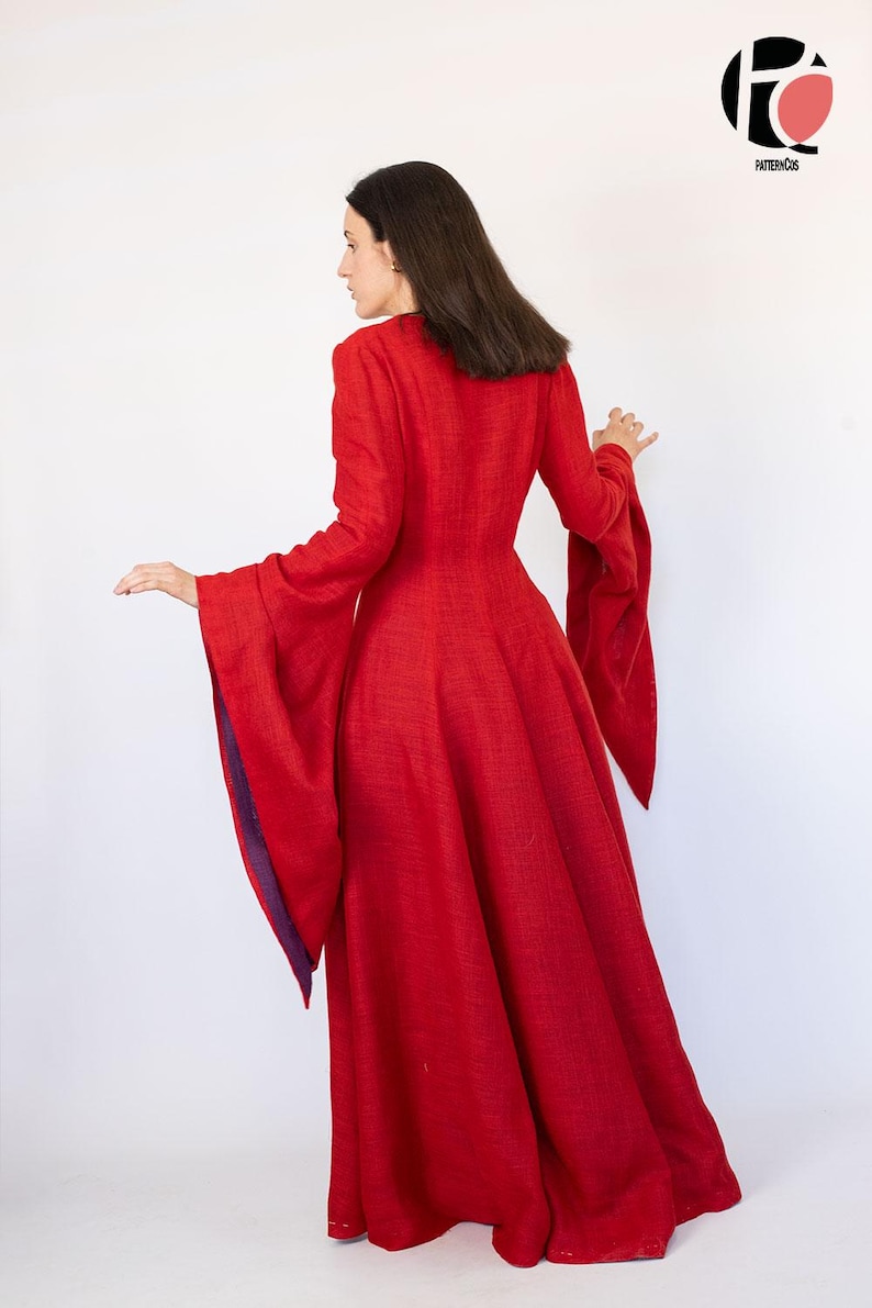 May include: A long, red dress with long sleeves and a flared skirt. The sleeves have a wide, bell-like shape with a purple lining. The dress is made of a textured fabric and has a high neckline. The dress is a solid red color.