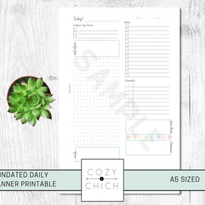 May include: A printable daily planner in A5 size with sections for today's top three tasks, a schedule, and a to-do list. The planner has a dotted grid for note-taking and a colorful design.