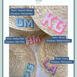 May include: A collection of straw hats featuring custom painted two-toned monograms. Each hat displays two-letter initials with a main color and a shadow color, including combinations like Island Water with Periwinkle, Blush with Watermelon, and Mint with Periwinkle. The brand name three little birds & co. is visible.