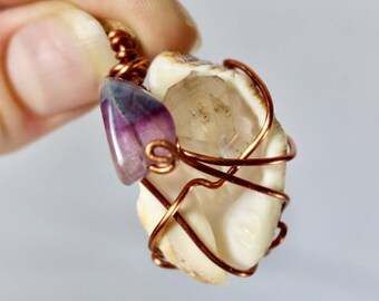 Hand wrapped crystal pendant necklace. Green and purple fluorite and raw quartz wrapped in a shell with wire