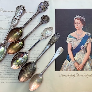 May include: A collection of vintage silver spoons with ornate handles, displayed alongside a portrait of Queen Elizabeth II. The spoons feature detailed designs and crests. The image also includes text from a program.