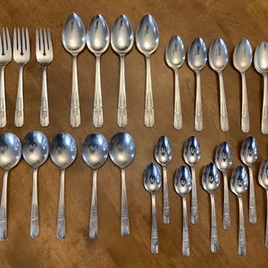 May include: A set of three ceramic mugs with a speckled, matte finish in cream, light grey, and dark grey. Each mug has a simple, minimalist design, suitable for coffee or tea.