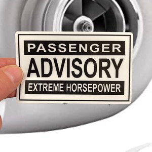 May include: White sticker with black text that reads "Passenger Advisory Extreme Horsepower".