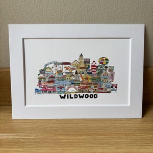 May include: A colorful illustration of the Wildwood, New Jersey boardwalk, featuring iconic landmarks and attractions, including a Ferris wheel, a lighthouse, and a roller coaster. The text "WILDWOOD" is printed below the illustration.