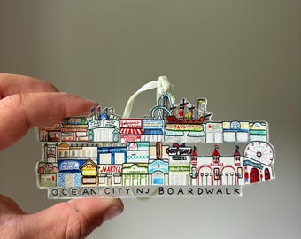 May include: A colorful illustration of the Ocean City, NJ boardwalk, featuring various shops and attractions, including a Ferris wheel, a roller coaster, and a carousel. The text "OCEAN CITY NJ BOARDWALK" is printed at the bottom.