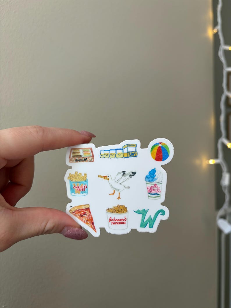 May include: A white sticker featuring a collection of colorful illustrations including a box of fries labeled Curley's Fries, a seagull, a cup of Johnson's Popcorn, a slice of pizza, a beach ball, a soft serve ice cream cup, and a green letter W.