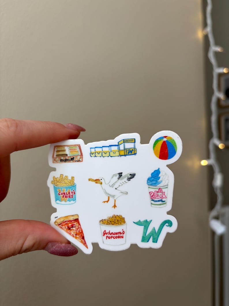 May include: A white sticker featuring colorful illustrations of boardwalk snacks and items, including a box of fries labeled Curleys Fries, a seagull, a cup of Polish water ice, a slice of pizza, and a bucket labeled Johnson's Popcorn.