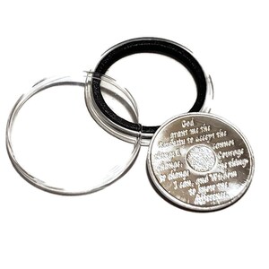 AA birthday chip holder opens and closes interchangeable coin capsule.
