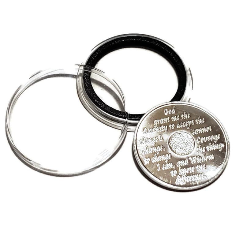 AA birthday chip holder opens and closes interchangeable coin capsule.