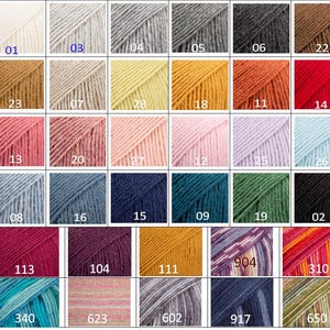May include: A color chart of yarn samples with numbers 01 through 310, 602, 623, 650, 904, and 917. The yarn samples are arranged in rows and columns, and each sample is a different color.