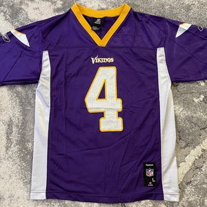 May include: Purple and white football jersey with the number 4 in white and gold. The jersey has a yellow collar and white side panels. The word "Vikings" is above the number. The jersey is a size L.