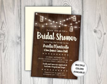 May include: Rustic wood background with string lights and mason jars. Text reads "Please join us for a Bridal Shower honoring the bride-to-be Ariella Monticello & her fiancé Lance Hall. Saturday, September 3rd, Crystal Gardens Country Club, 11am-2pm, 1234 Main Street, Brighton, MI. Ariella and Lance are registered at Bed Bath & Beyond and Target. Please R.S.V.P. by August 17th, emily@gmail.com, 555.123.4567. Multiple colors available!"