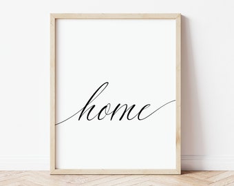 May include: A framed print with the word "home" written in a cursive font on a white background.