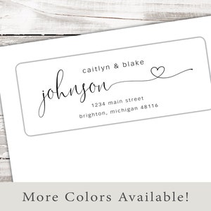 May include: White return address label with black text. The text reads "caitlyn & blake johnson 1234 main street brighton, michigan 48116". A small heart symbol is drawn next to the name.