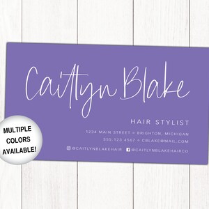 May include: A purple business card with white text that reads "Caitlyn Blake Hair Stylist" with contact information including address, phone number, and email address. The card also includes social media handles for Instagram and Facebook. A white circle with black text reads "Multiple Colours Available!"