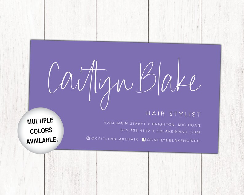 May include: A purple business card with white text that reads "Caitlyn Blake Hair Stylist" with contact information including address, phone number, and email address. The card also includes social media handles for Instagram and Facebook. A white circle with black text reads "Multiple Colours Available!"
