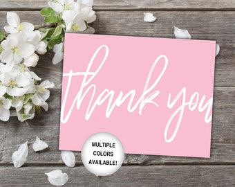 May include: Pink thank you card with white calligraphy. The card has a white circle with the text "Multiple Colors Available!" on it.