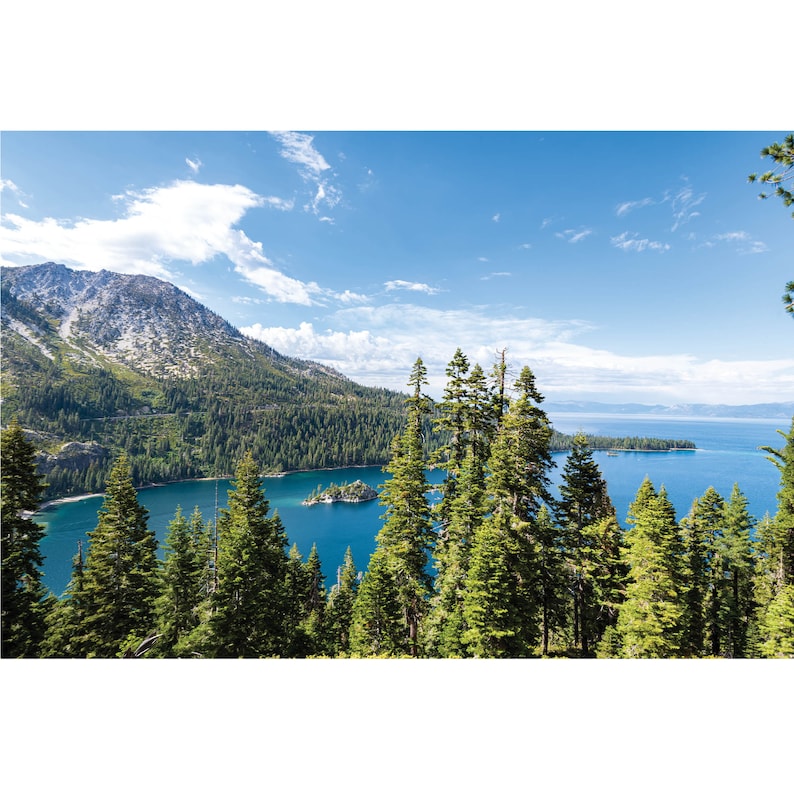 May include: A scenic view of a lake surrounded by lush green trees and mountains. The water is a deep blue and the sky is a clear blue with white clouds.