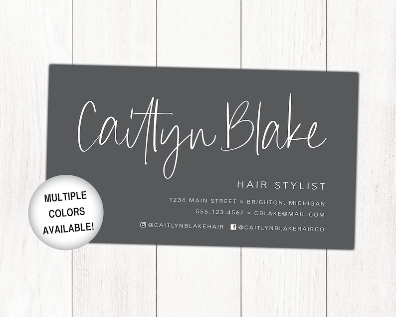May include: A grey business card with white text. The card reads "Caitlyn Blake Hair Stylist" and includes contact information: 1234 Main Street, Brighton, Michigan, 555.123.4567, cblake@mail.com, @caitlynblakehair, @caitlynblakehairco.