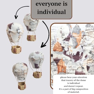 May include: Three white fabric hot air balloons with brown wicker baskets. Each balloon has a unique design of black and brown printed text and patterns. The text on the balloons includes the words "everyone is individual" and "please bear your attention that tracery of the dome is individual and doesn't repeat. It's a part of big composition of material."
