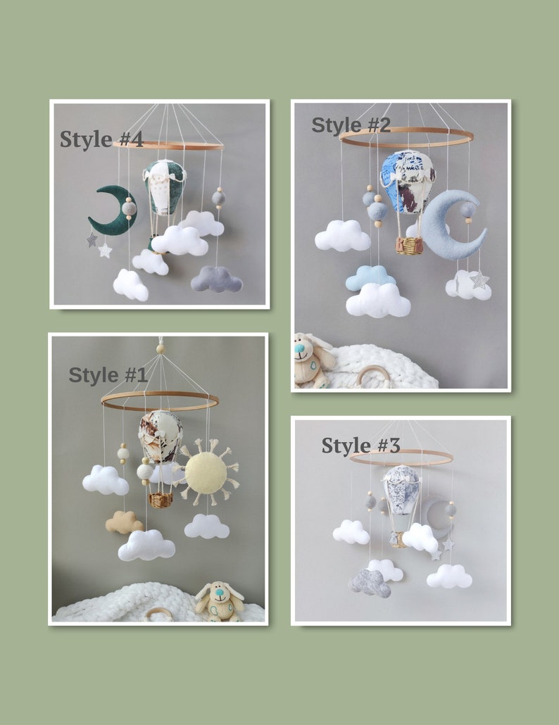 May include: Four different styles of baby mobile featuring a hot air balloon, clouds, stars, and a moon. The mobiles are made of felt and wood. Style #1 has a yellow sun, Style #2 has a blue moon, Style #3 has a gray moon, and Style #4 has a green moon.