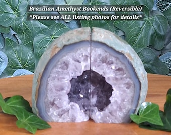 May include: Two halves of a Brazilian amethyst geode forming bookends. The exterior is a rough, pale green stone, while the interior features deep purple, crystalline amethyst points surrounded by concentric bands of white and gray agate.