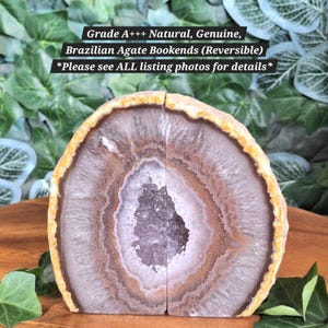 May include: Two halves of a natural Brazilian agate geode forming bookends with a crystalline center, brown and white concentric banding, and a yellow-orange outer crust. Text reads: Grade A+++ Natural, Genuine, Brazilian Agate Bookends (Reversible).