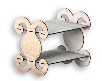 May include: A two-tiered wooden shelf with a decorative, ornate design. The shelf is made of light-colored wood with a natural grain pattern. The shelf is perfect for displaying small items or plants.