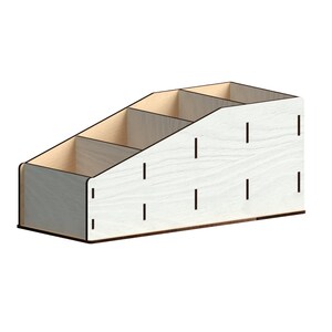 May include: White wooden desk organiser with four compartments. The organiser has a slanted design and is made of wood with a light wood grain finish.