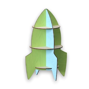 May include: A green and blue rocket-shaped bookshelf with three shelves. The bookshelf is made of wood and has a modern design.