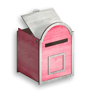 May include: A pink wooden mailbox with a white woodgrain pattern. The mailbox has a hinged lid that is open and a slot for mail. The mailbox is sitting on a white surface.