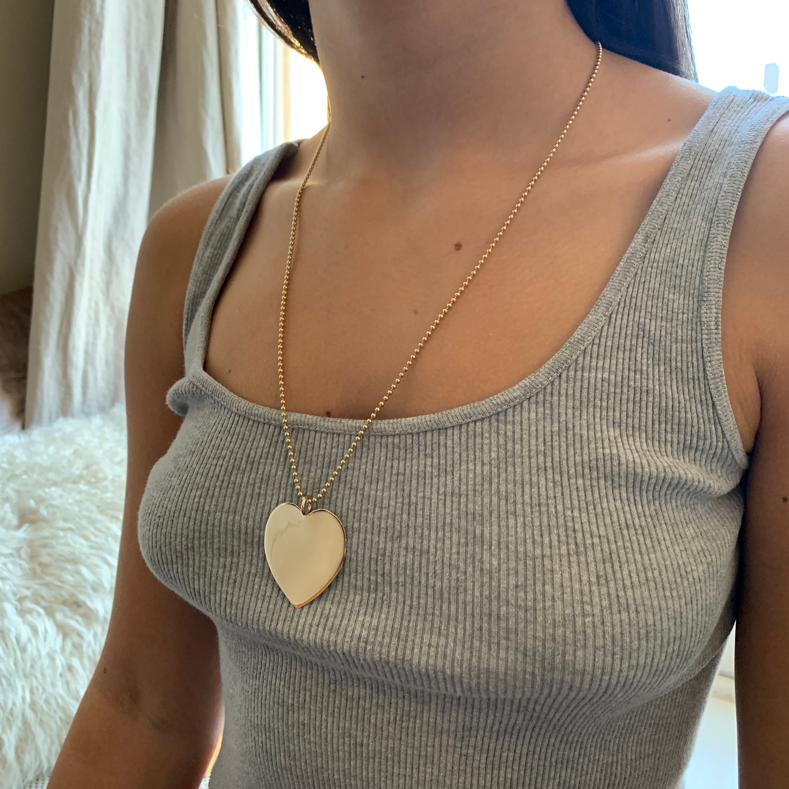 Large gold heart best sale pendant