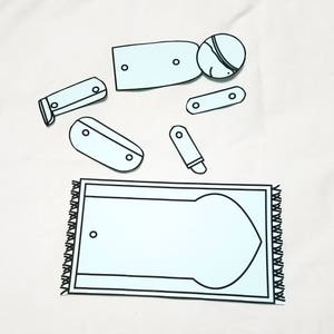 May include: A printable paper craft activity for children featuring a person praying on a prayer rug. The paper craft includes a person, a prayer rug, and several pieces to cut out and assemble.