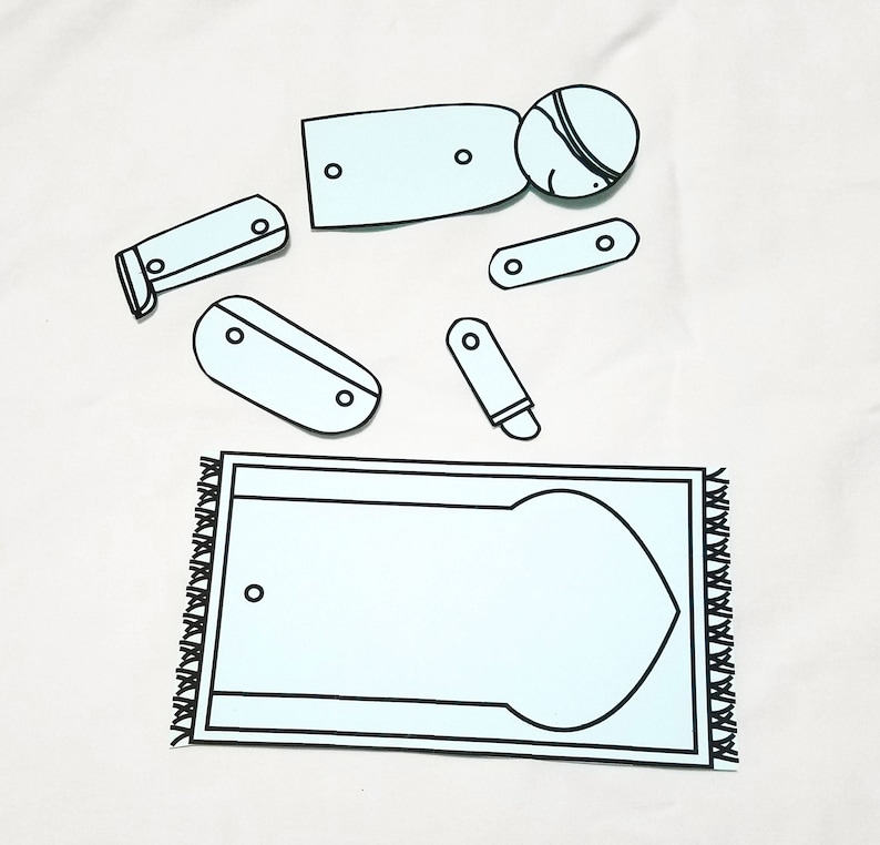 May include: A printable paper craft activity for children featuring a person praying on a prayer rug. The paper craft includes a person, a prayer rug, and several pieces to cut out and assemble.