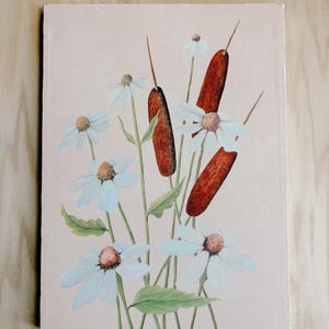 May include: A rectangular canvas painting on a light pink background featuring a botanical arrangement of white daisies with yellow centers and brown cattails on green stems. The artwork displays a collection of flowers and reeds.