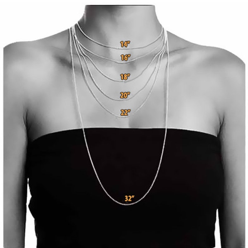 May include: A model wearing a silver chain necklace in various lengths, from 14 inches to 32 inches. The necklace is shown on a person with a black top.