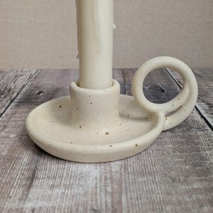 Ceramic tall candle holder with small loop handle, satin cream speckled glaze