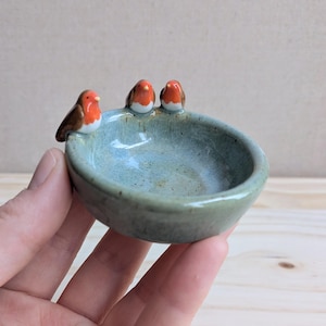 Small ring dish with three robins, flecked turquoise glaze