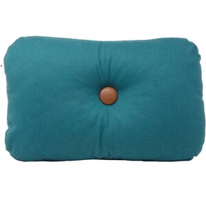 May include: Teal blue rectangular pillow with a brown button in the center.