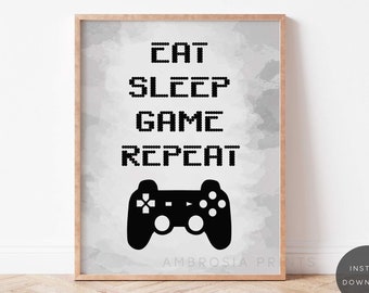 Puede incluir: Un póster imprimible en blanco y negro con un fondo de acuarela gris. El póster presenta un mando de videojuego y el texto "Comer Dormir Jugar Repetir".