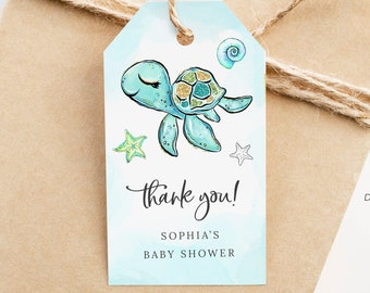 May include: A blue and green thank you tag with a cartoon turtle, seashells, and stars. The text reads "Thank you! Sophia's Baby Shower".