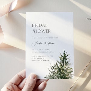 Pode incluir: Um cartão branco com uma ilustração de aquarela de pinheiros. O cartão é um convite para um chá de panela para Julia Wilson, que será realizado no dia 1 de outubro às 18:00 no The Wild Flower Bar & Dinner. RSVP até 20 de setembro para Melissa no 354-4756. O convite está registrado na Amazon.