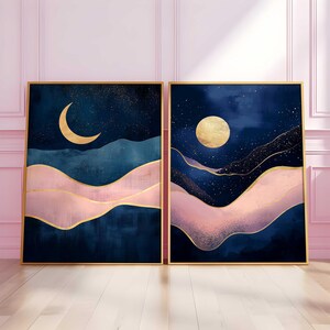May include: Two abstract landscape paintings with a dark blue background, pink and gold accents, and a crescent moon and full moon in the sky.