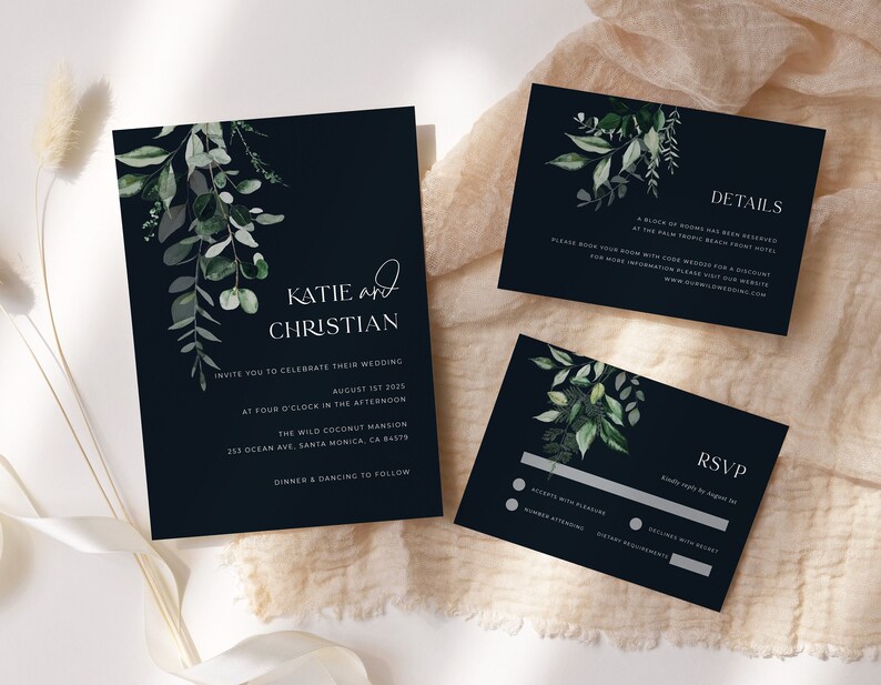 May include: Navy blue wedding invitation suite with botanical watercolor greenery. The invitation includes the names "Katie and Christian", event details, and venue information. The suite also includes RSVP and details cards.