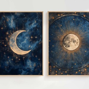 May include: Two framed prints with a celestial theme. The first print features a crescent moon with a gold outline against a dark blue background with gold stars. The second print features a full moon with a gold outline and rays of light emanating from it against a dark blue background with gold stars.